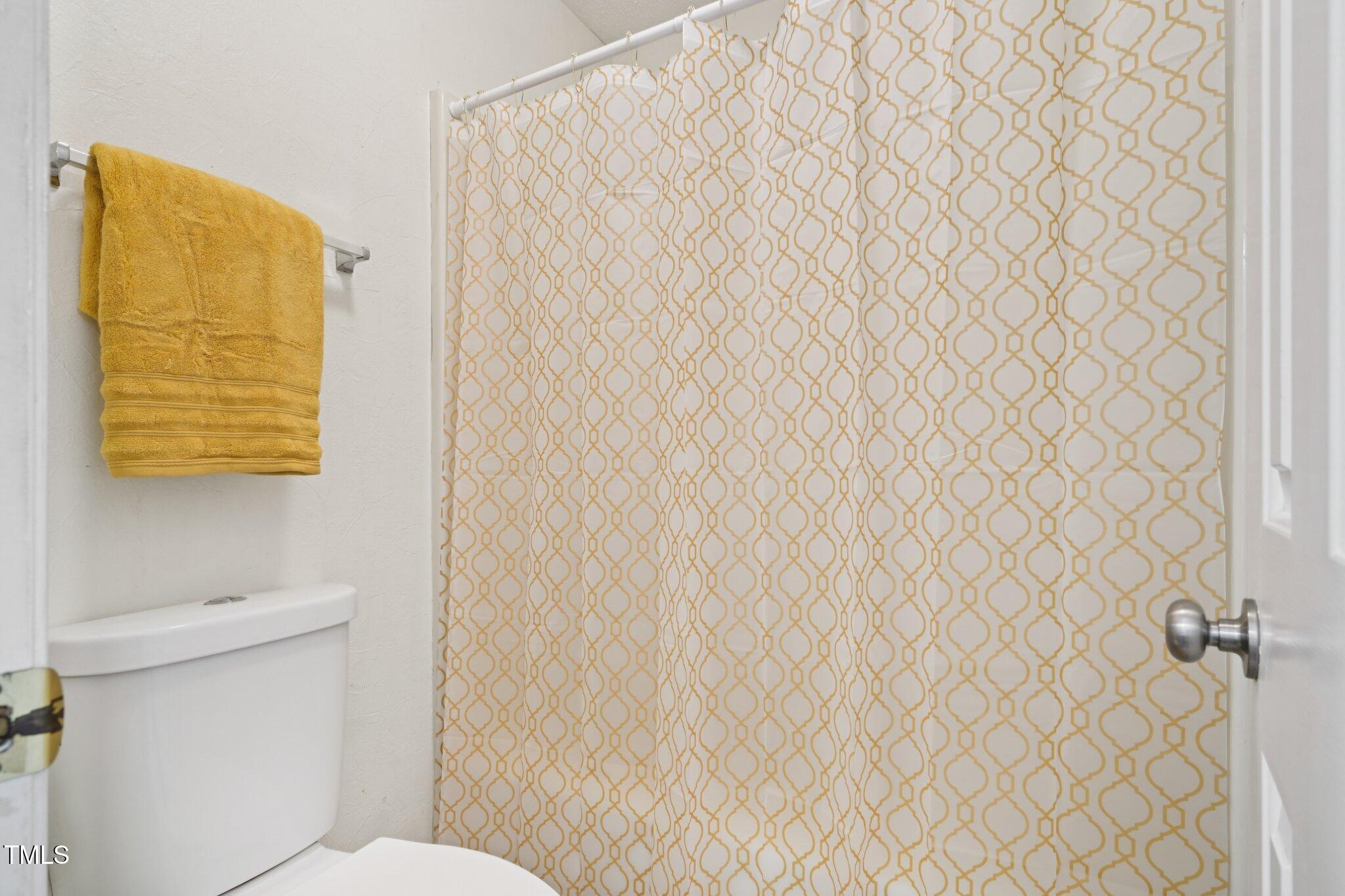 3534 Rawdon Drive Durham, NC 27713 - Photo 31 of 43 a bathroom with a toilet and a shower curtain