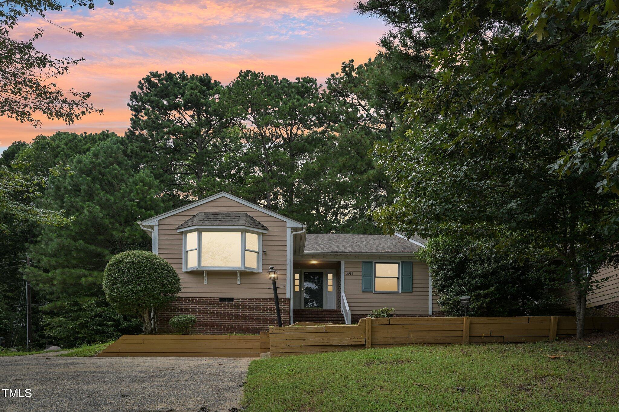 3534 Rawdon Drive Durham, NC 27713 - Photo 35 of 43 a front view of a house with a yard and garage