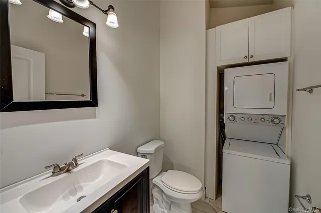 a bathroom with a sink a toilet and mirror
