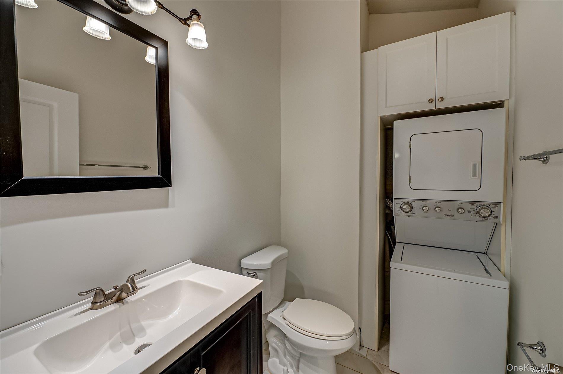50 Stewart Avenue, Unit 3A Huntington, NY 11743 - Photo 11 of 13 a bathroom with a sink a toilet and mirror