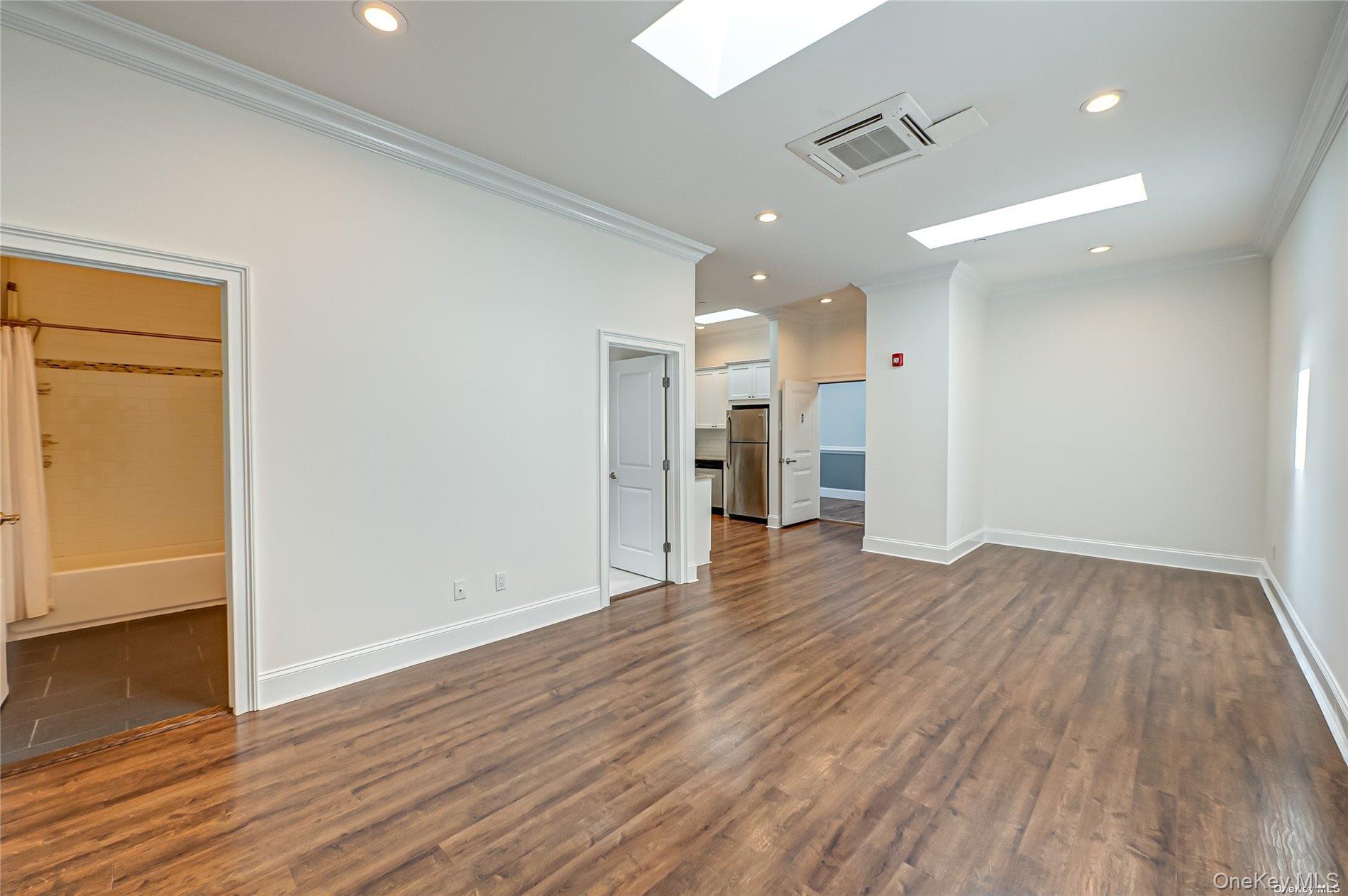 50 Stewart Avenue, Unit 3A Huntington, NY 11743 - Photo 4 of 13 wooden floor in an empty room with wooden floor