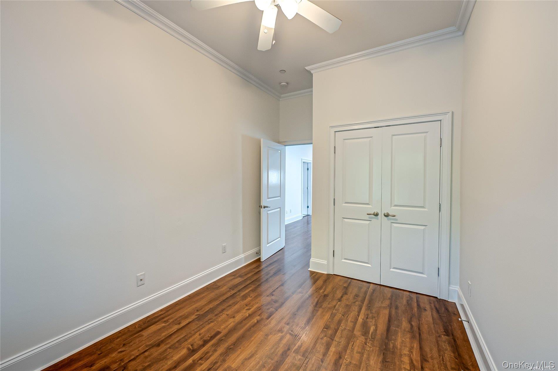 50 Stewart Avenue, Unit 3A Huntington, NY 11743 - Photo 10 of 13 a view of a room with wooden floor and a ceiling fan