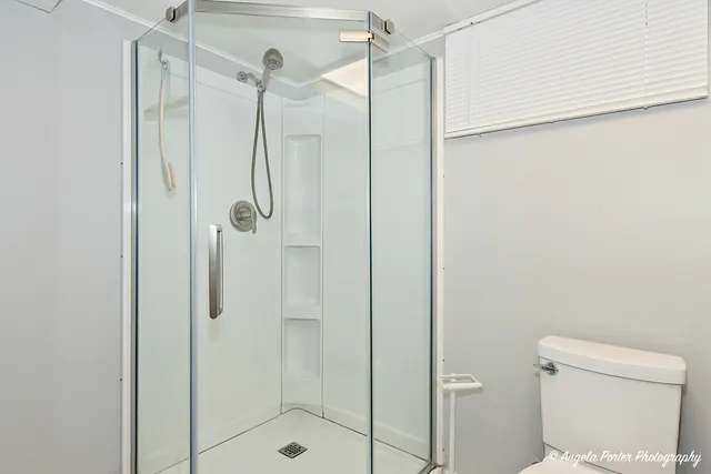 a bathroom with a shower and toilet