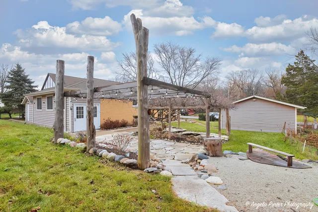 a view of a chair and table in the yard