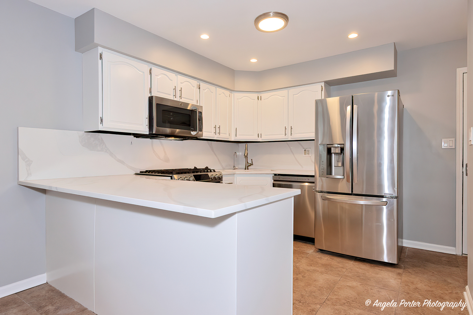 40 Pine Tree Row Lake Zurich, IL 60047 - Photo 6 of 31 a kitchen with stainless steel appliances a refrigerator stove microwave and sink