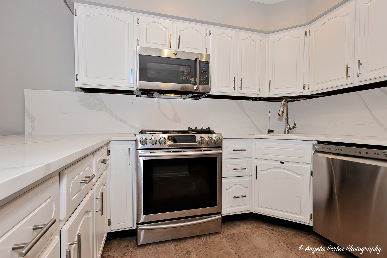 40 Pine Tree Row Lake Zurich, IL 60047 - Photo 7 of 31 a kitchen with stainless steel appliances white cabinets and a stove a microwave oven with white cabinets