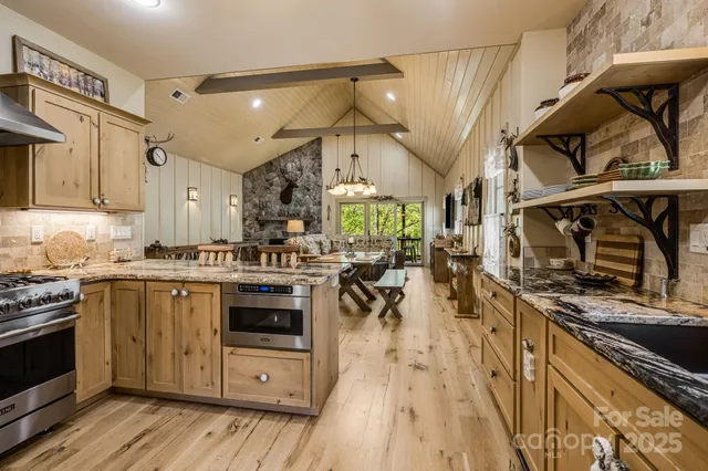 a kitchen with lots of counter top space and stainless steel appliances