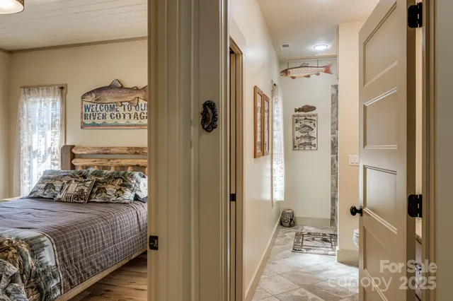 a bedroom with a bed and a refrigerator