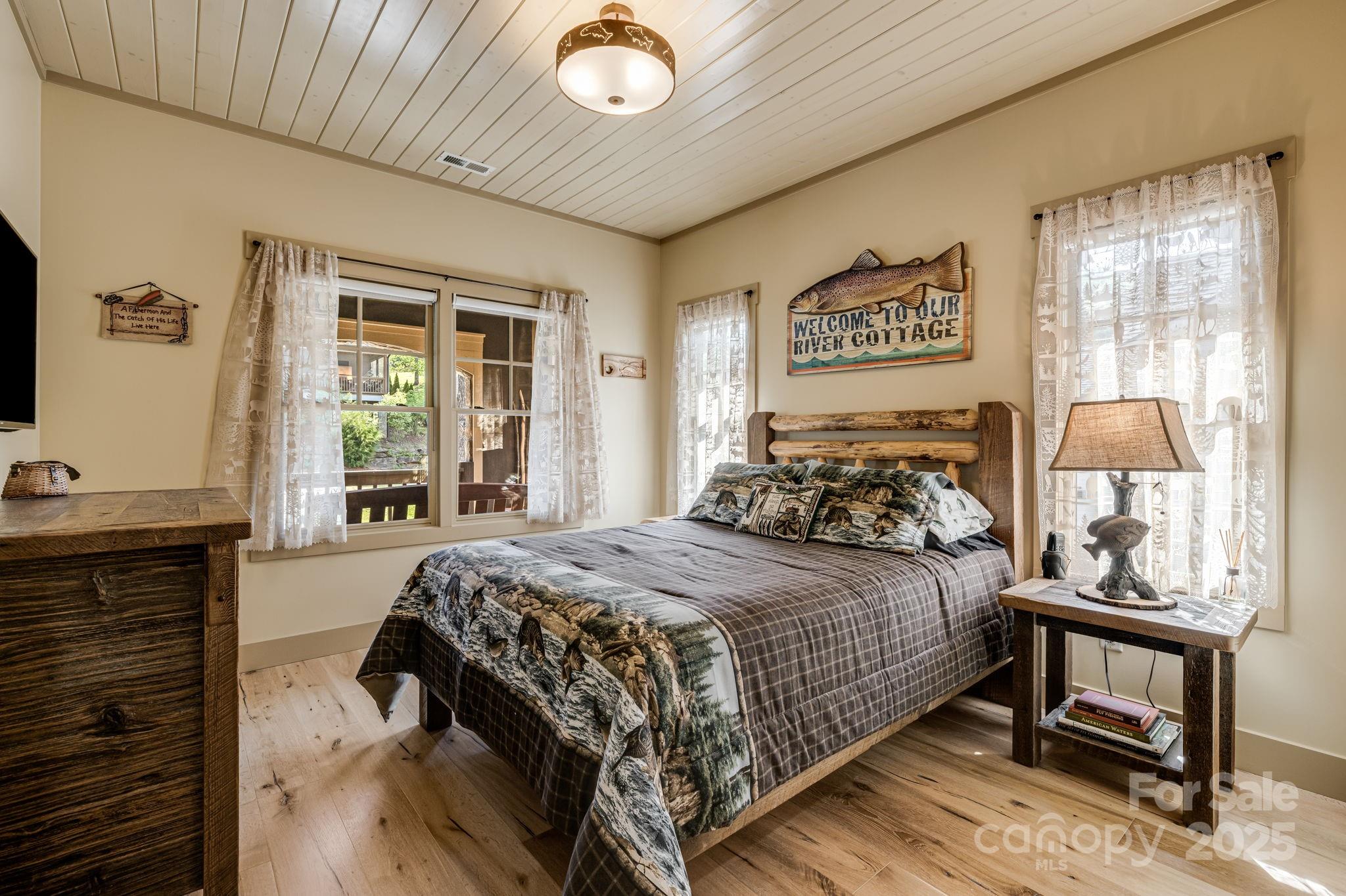 36 Chimney Stone Way Cullowhee, NC 28723 - Photo 19 of 47 a bedroom with a bed and a flat screen tv