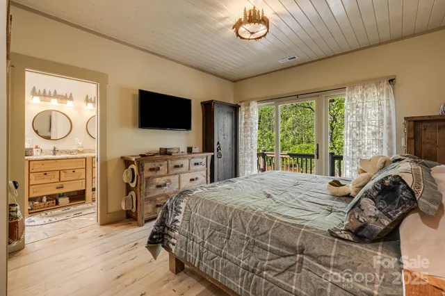 a bedroom with a bed and a television