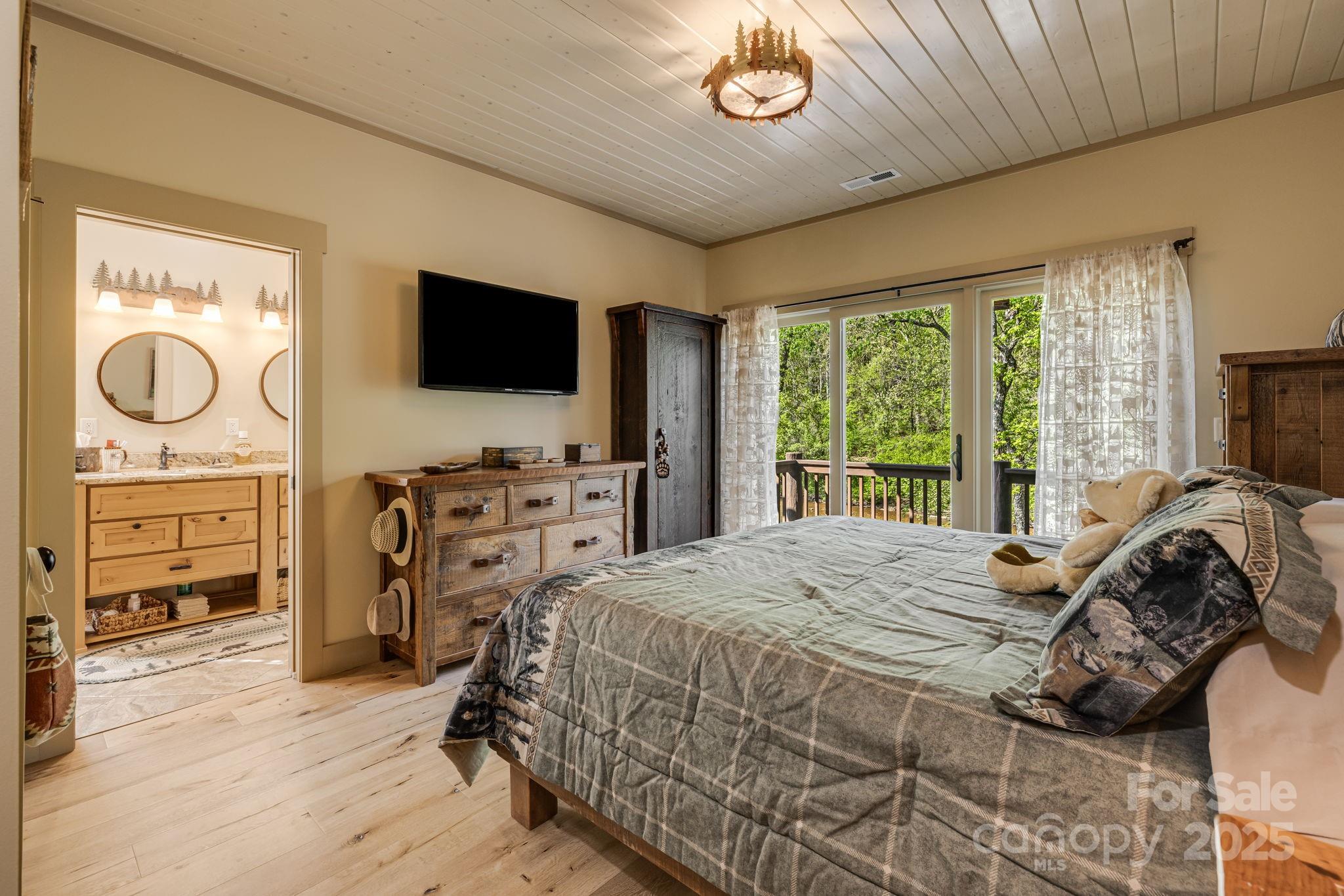 36 Chimney Stone Way Cullowhee, NC 28723 - Photo 21 of 47 a bedroom with a bed and a television