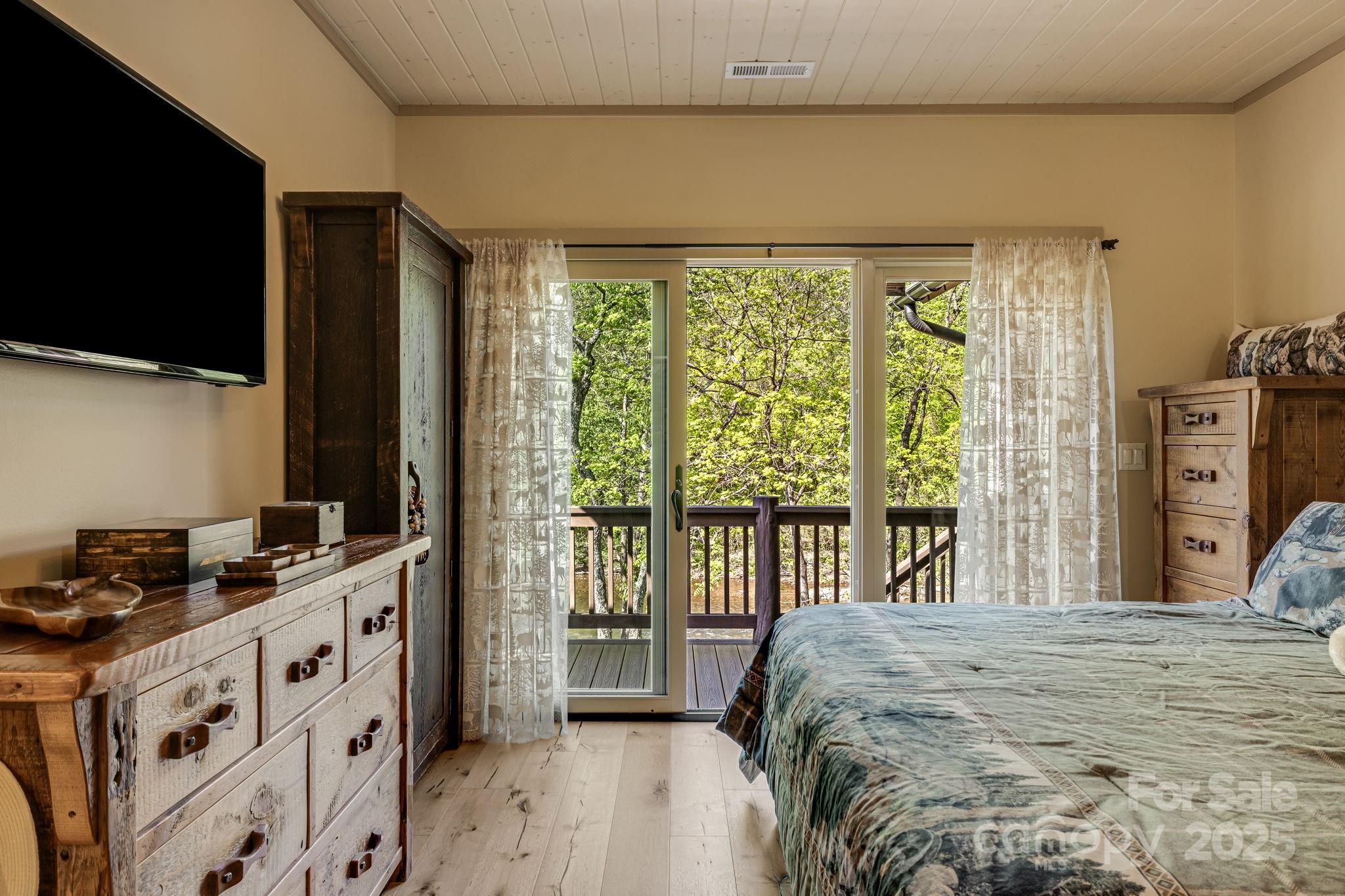 36 Chimney Stone Way Cullowhee, NC 28723 - Photo 22 of 47 a bed sitting in a bedroom next to a window