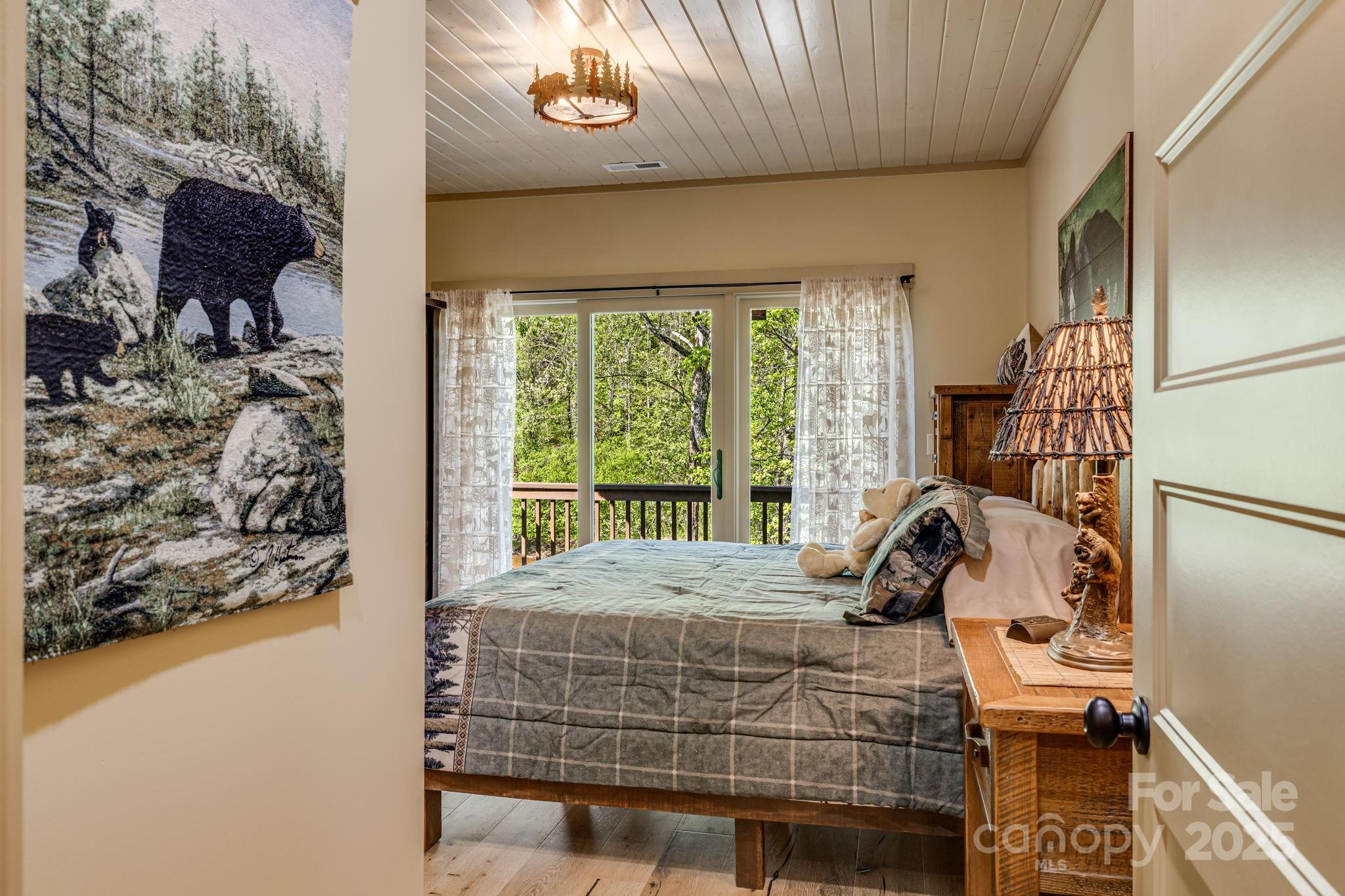 36 Chimney Stone Way Cullowhee, NC 28723 - Photo 24 of 47 a bed sitting in a bedroom next to a window