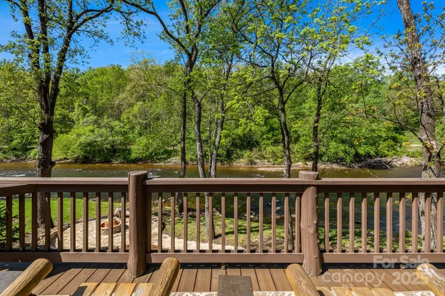 a view of a balcony with wooden floor and fence