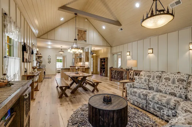 a very nice looking living room with furniture and a chandelier