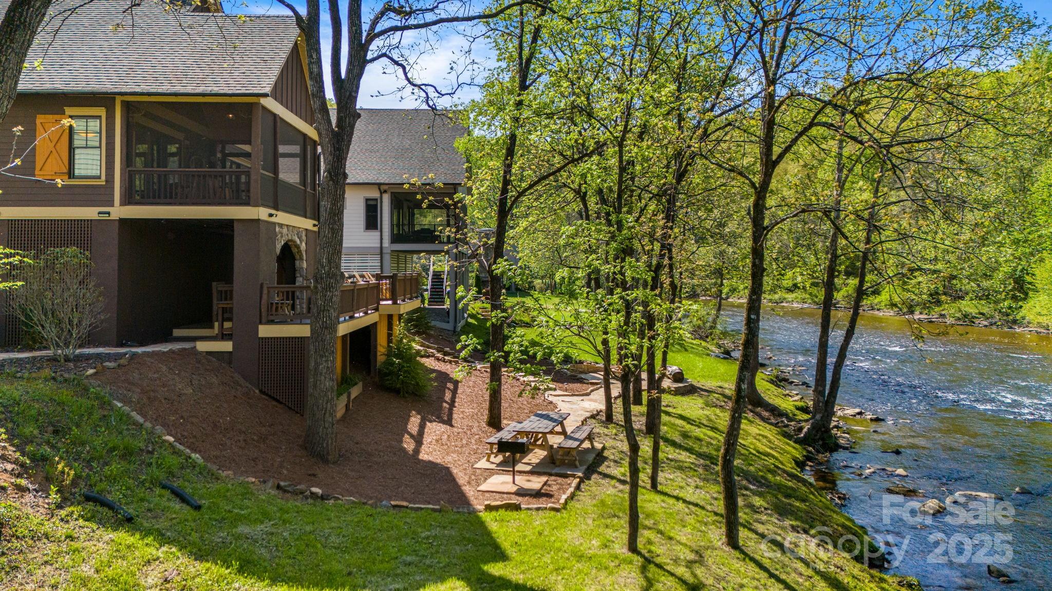 36 Chimney Stone Way Cullowhee, NC 28723 - Photo 44 of 47 a view of a patio with table and chairs under an umbrella