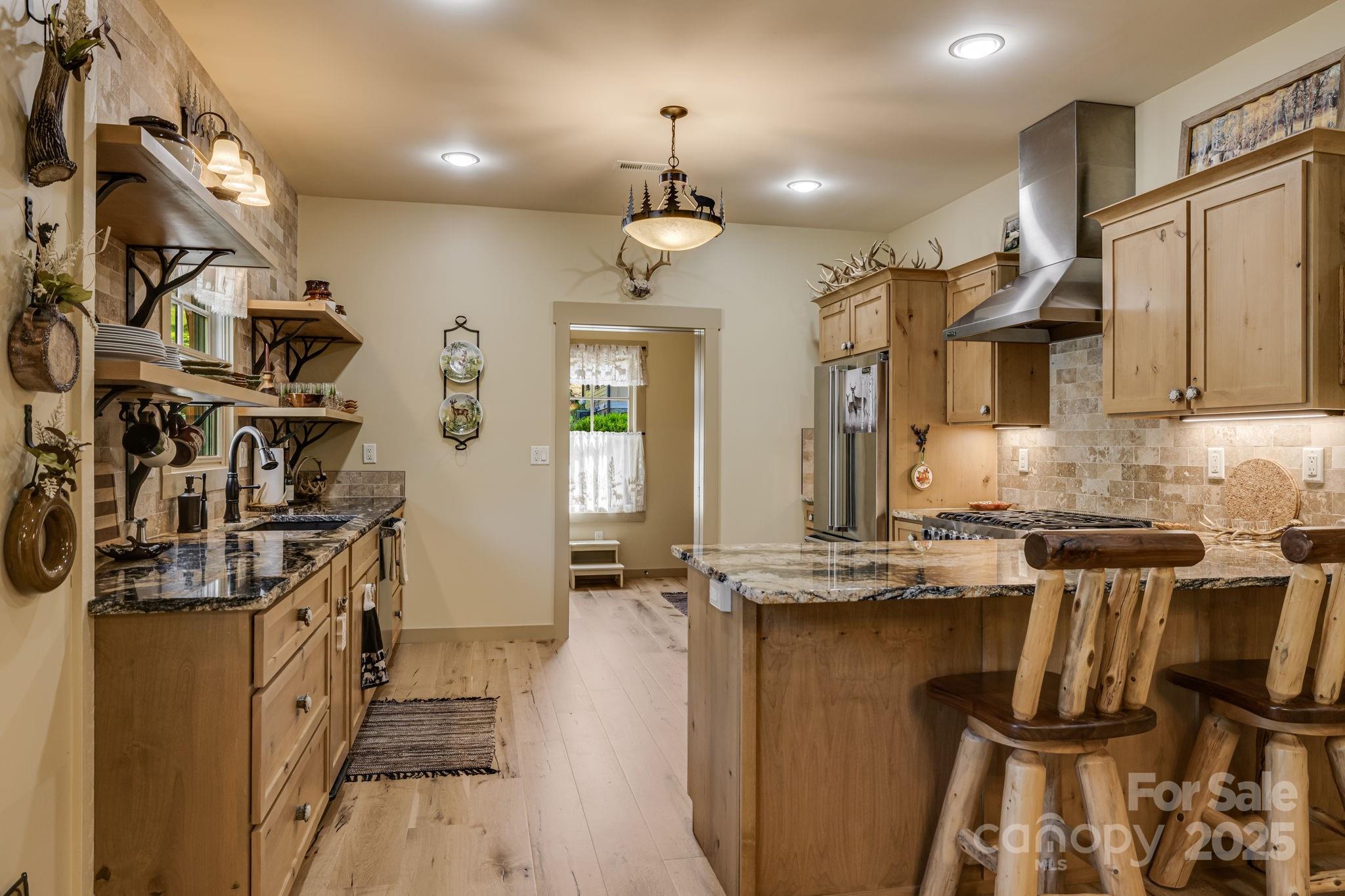 36 Chimney Stone Way Cullowhee, NC 28723 - Photo 7 of 47 a kitchen with stainless steel appliances granite countertop a sink and wooden cabinets