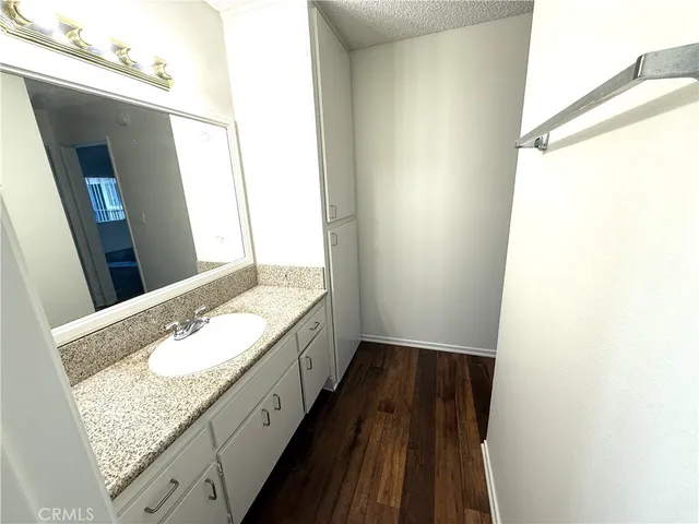 a bathroom with a granite countertop sink and a mirror