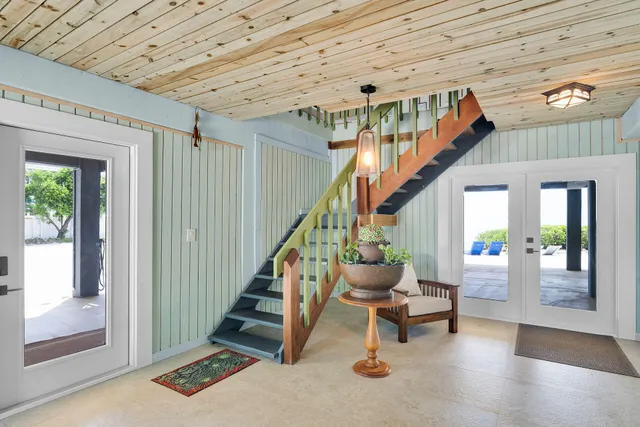 a view of an empty room with window and furniture