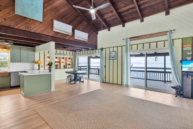 a swimming pool with large glass windows and a table