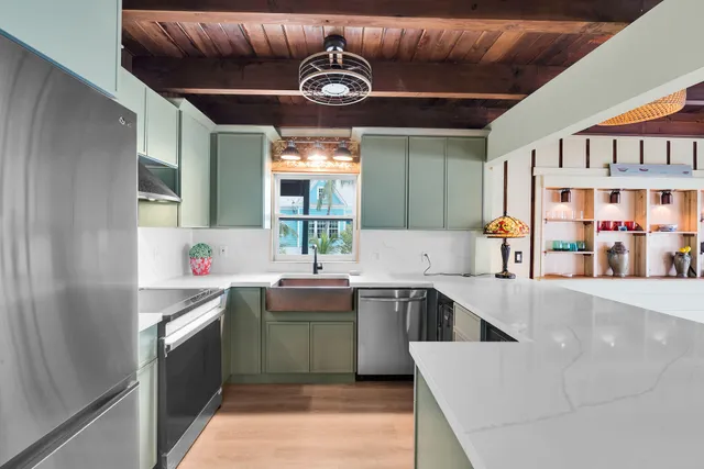 a kitchen with stainless steel appliances granite countertop a sink and a refrigerator