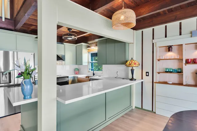 a kitchen with an oven a sink and a large window