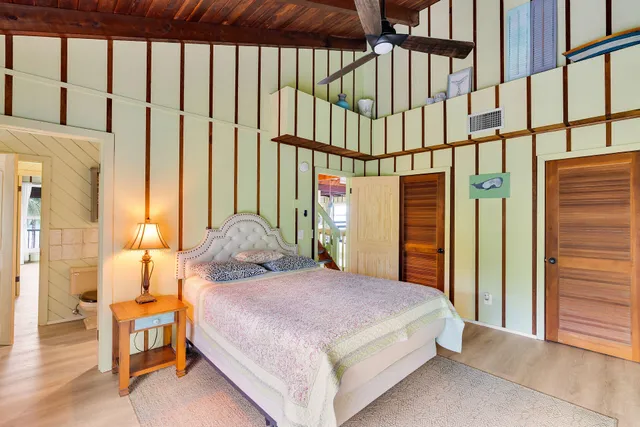 a spacious bedroom with a large bed and a large window