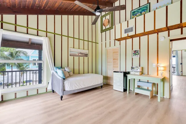 a bedroom with a bed and large window