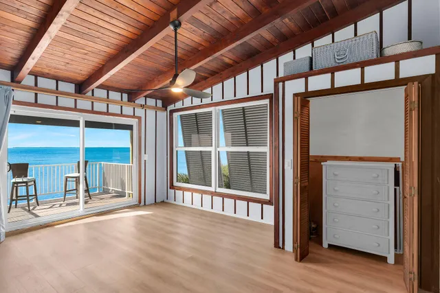 a balcony with chairs and wooden floor