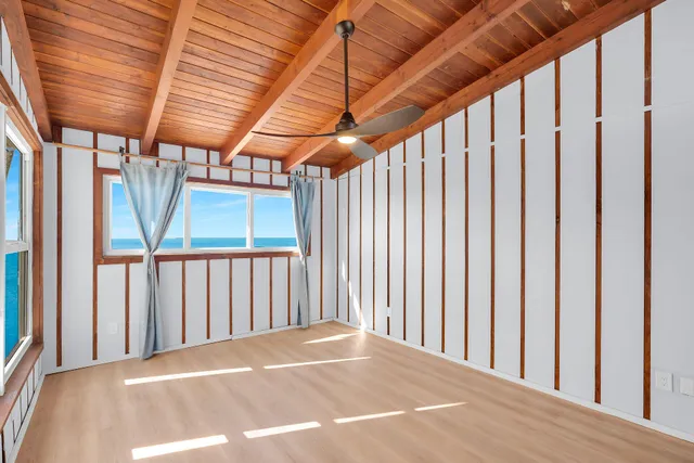 an aerial view of residential house with outdoor space and trees all around