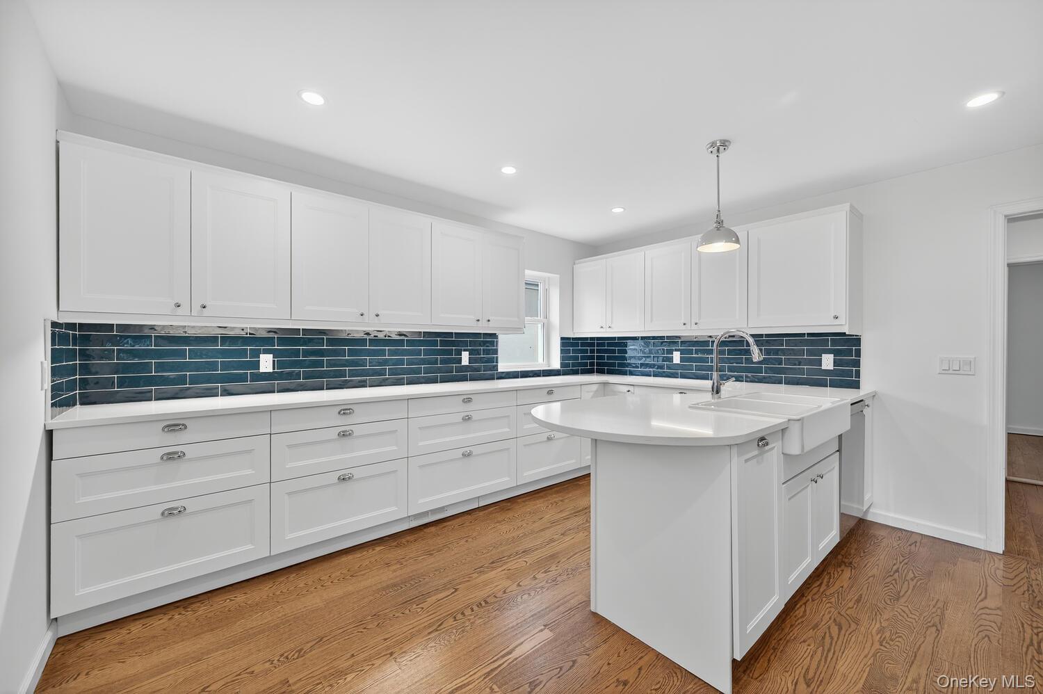 175 North Street Locust Valley, NY 11560 - Photo 17 of 40 a large kitchen with stainless steel appliances granite countertop a sink a stove and a wooden floors