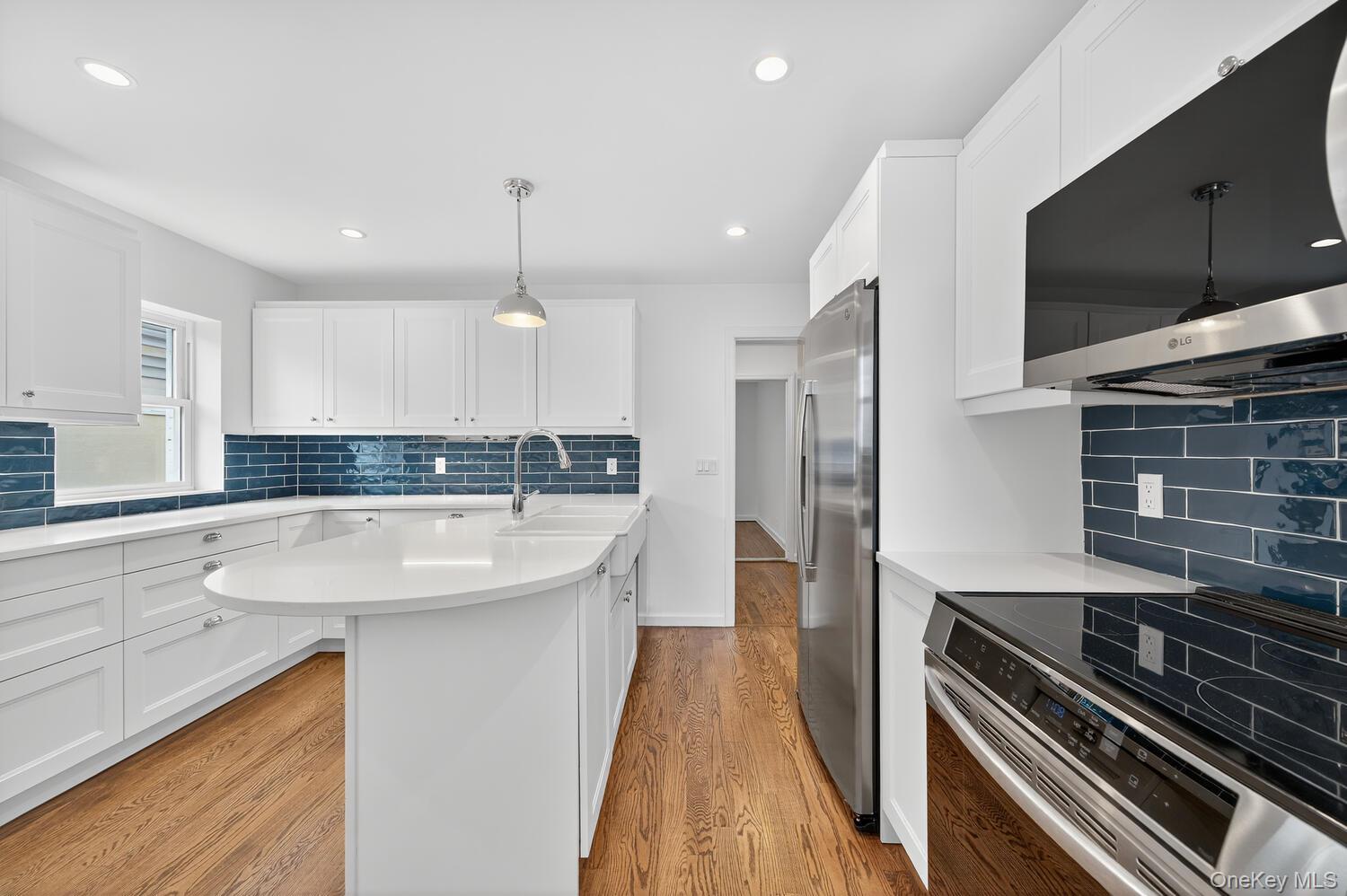 175 North Street Locust Valley, NY 11560 - Photo 18 of 40 a modern kitchen with stainless steel appliances granite countertop a sink and a stove