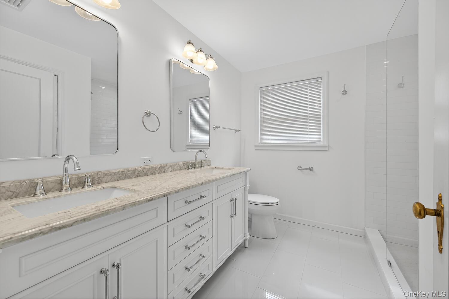 175 North Street Locust Valley, NY 11560 - Photo 25 of 40 a bathroom with a granite countertop double vanity sink a mirror and a toilet