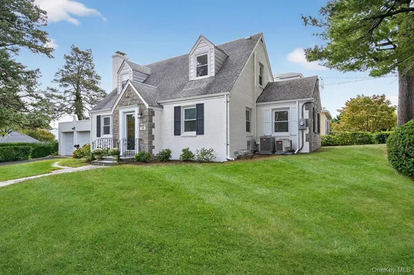 a front view of house with yard and green space