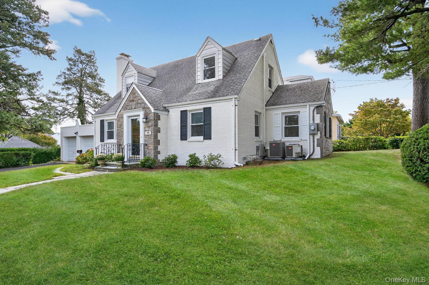 175 North Street Locust Valley, NY 11560 - Photo 33 of 40 a front view of house with yard and green space