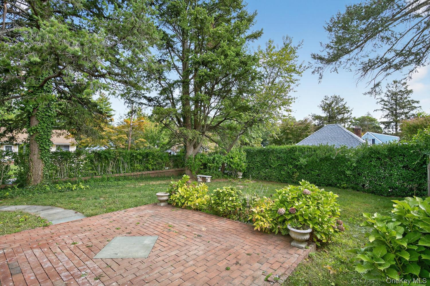 175 North Street Locust Valley, NY 11560 - Photo 34 of 40 a view of a garden with a tree