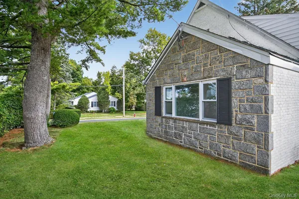 a view of house with backyard