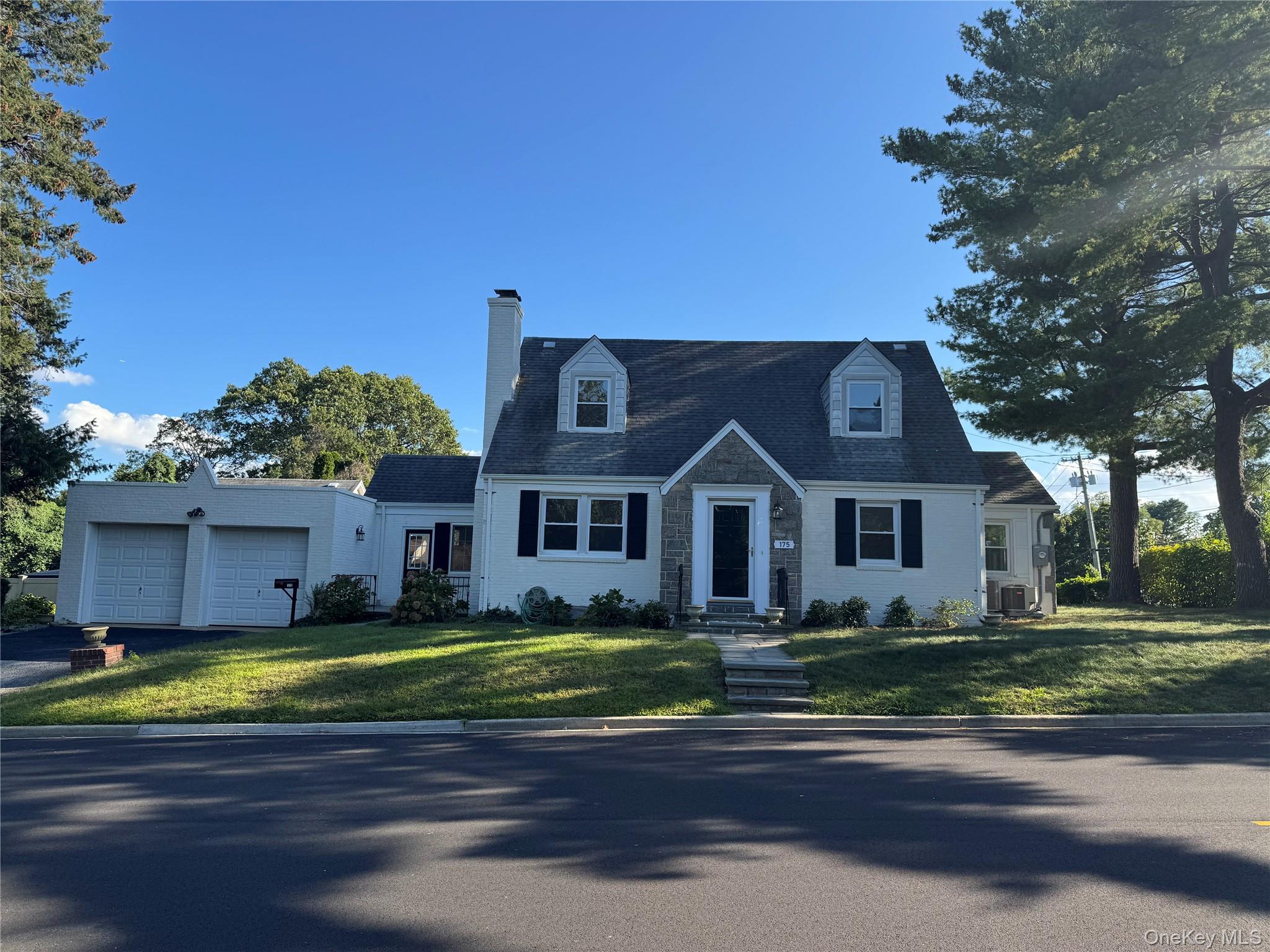 175 North Street Locust Valley, NY 11560 - Photo 37 of 40 a view of a house with a big yard and large trees