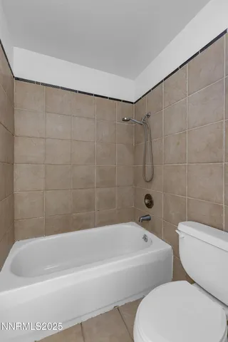 a white bath tub sitting next to a white toilet