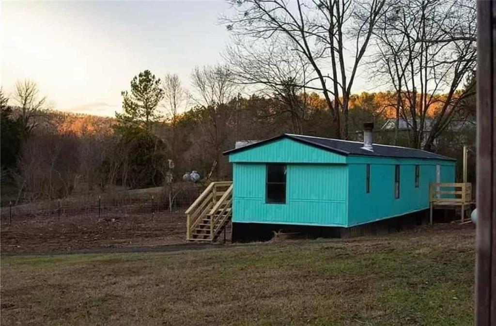 262 Blacks Bluff Road Southwest Rome, GA 30161 - Photo 2 of 11 a view of a wooden house with a yard