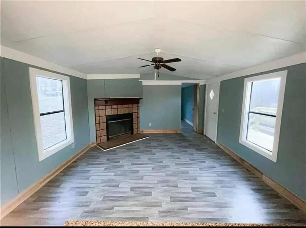 262 Blacks Bluff Road Southwest Rome, GA 30161 - Photo 7 of 11 an empty room with windows and fireplace