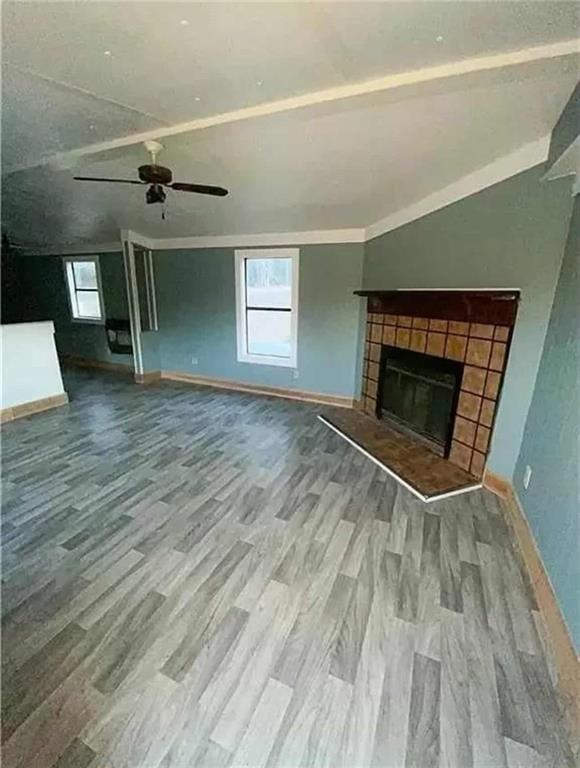 262 Blacks Bluff Road Southwest Rome, GA 30161 - Photo 8 of 11 an empty room with wooden floor fireplace and windows