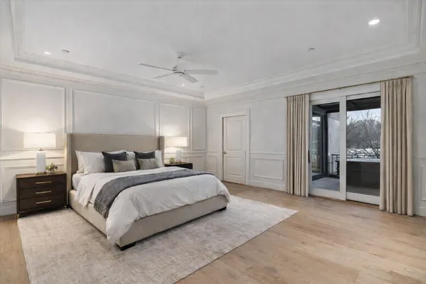 a spacious bedroom with a bed and a chandelier