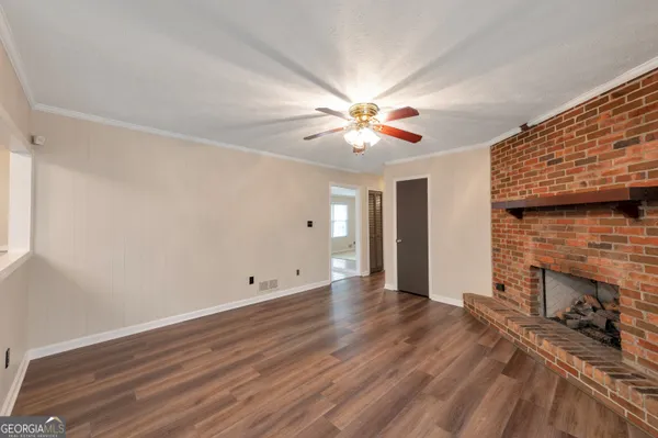 wooden floor in an empty room with a fireplace