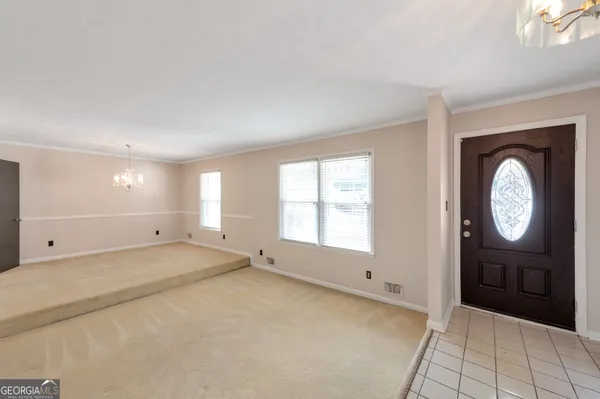 an empty room with windows and mirror