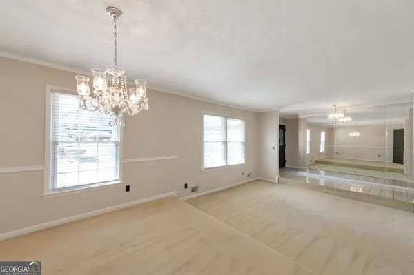 a view of a room with windows and chandelier