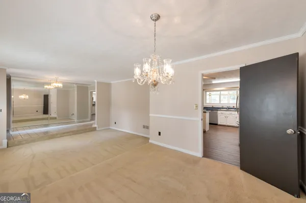 a view of a room with window and chandelier