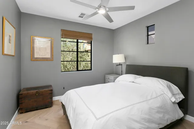 a bedroom with a bed and a window