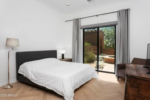 a bedroom with a bed and glass door