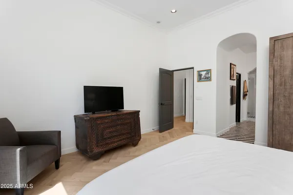 a bedroom with a bed and a television